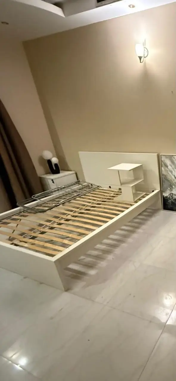 Wooden bed frame dismantled for donation pickup