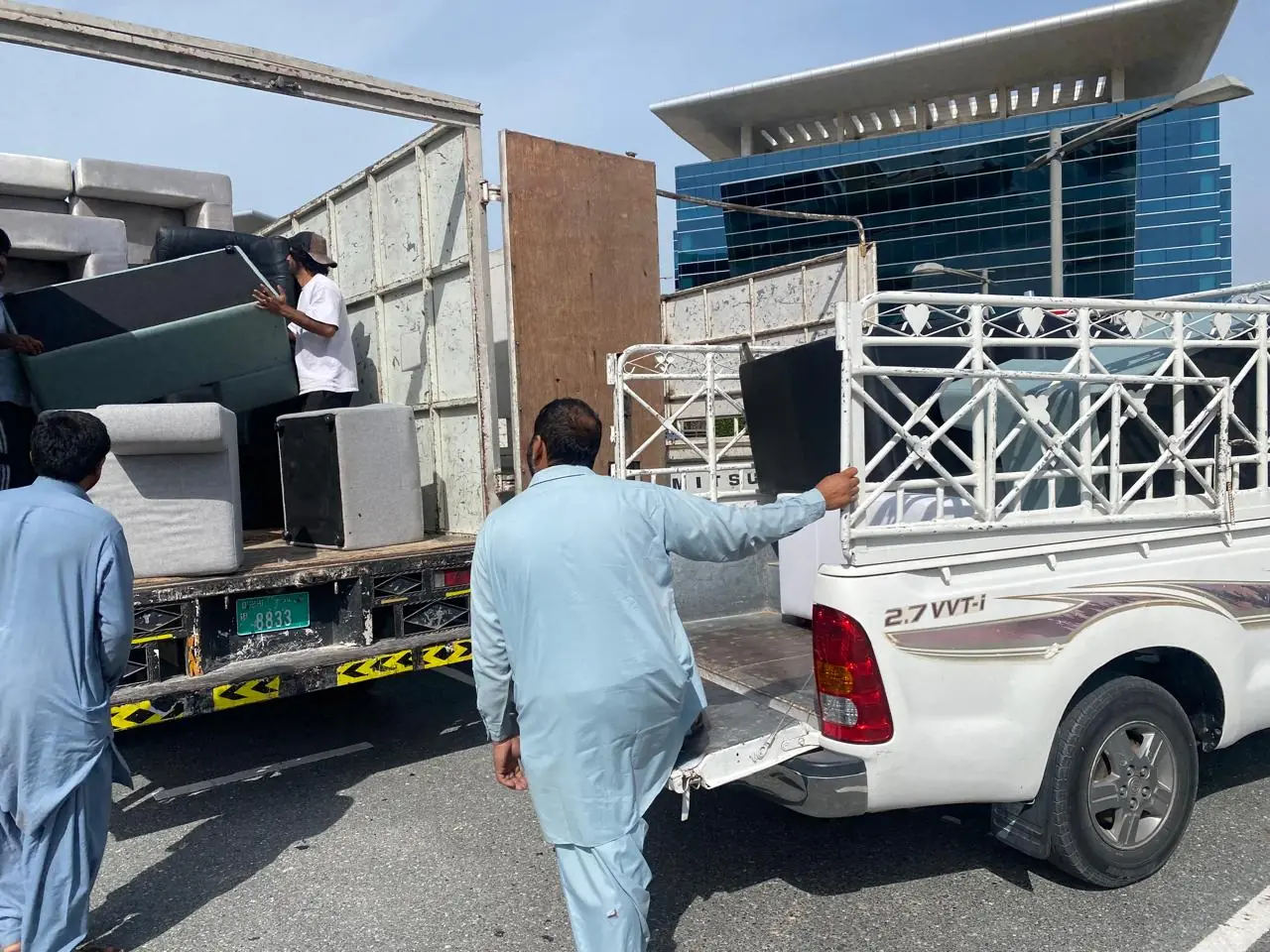Our crew loading donated furniture onto pickup trucks in Dubai