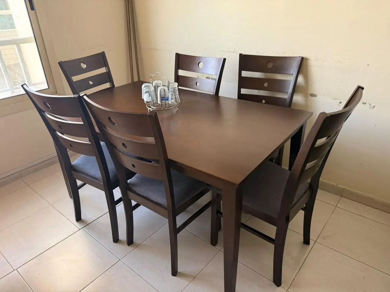 Wooden dining table and six chairs donated in Dubai